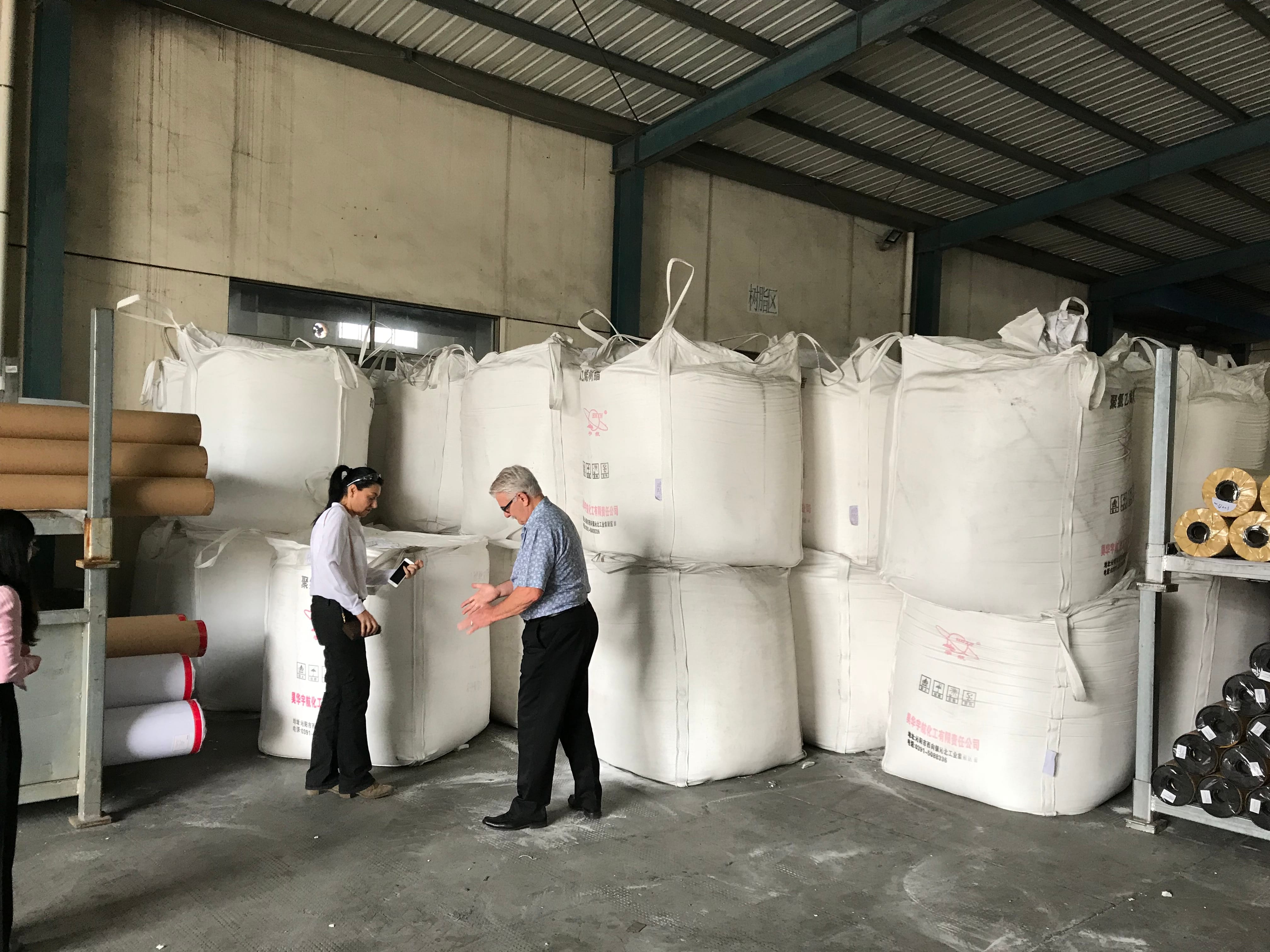 Insane Signs & Print inspecting materials with a manufacturing partner in China
